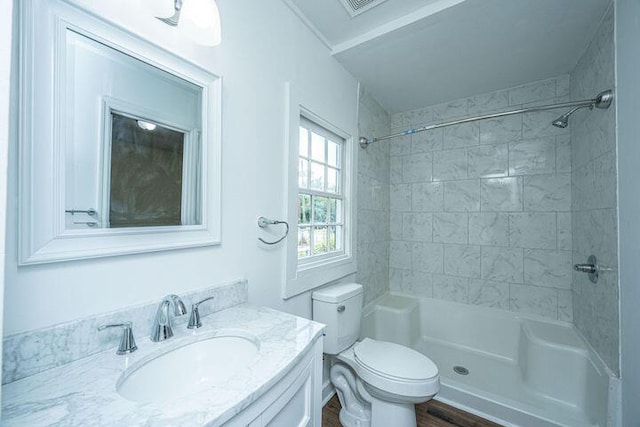 bathroom featuring toilet, walk in shower, and vanity