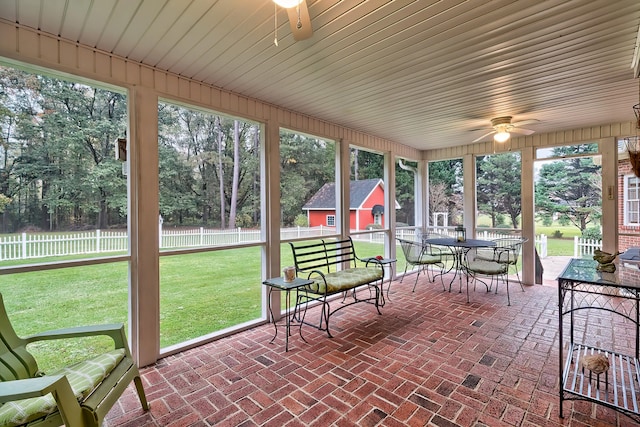 sunroom / solarium featuring a wealth of natural light and ceiling fan