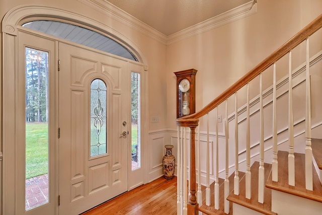 entrance foyer with light hardwood / wood-style flooring and ornamental molding