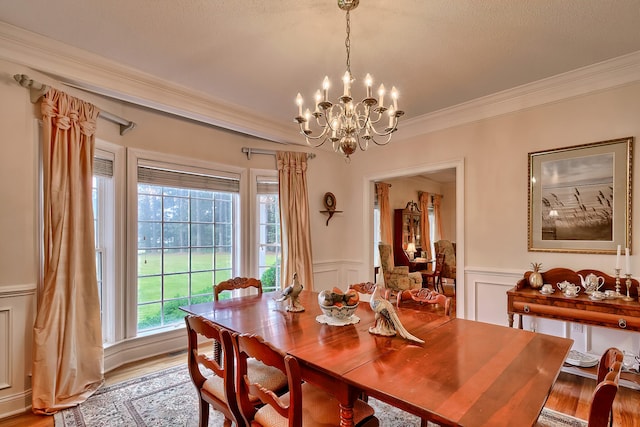 dining space with plenty of natural light, light wood-type flooring, and ornamental molding