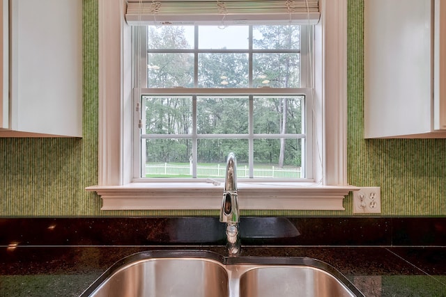 kitchen with white cabinets, sink, and a wealth of natural light