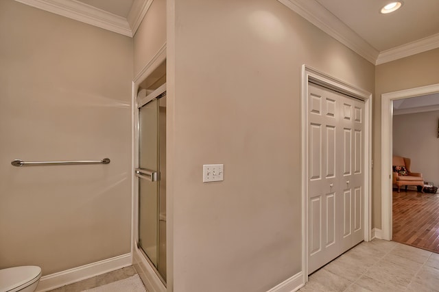 bathroom with a shower with door, toilet, wood-type flooring, and crown molding