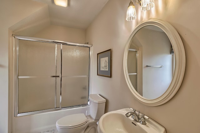 full bathroom featuring toilet, enclosed tub / shower combo, and sink