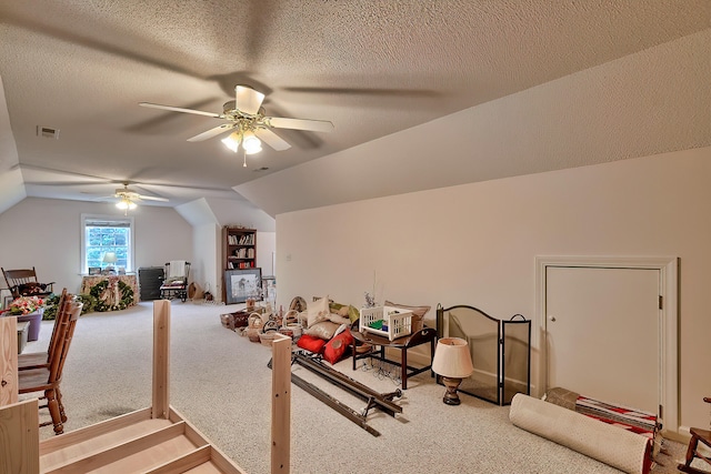 bonus room with a textured ceiling, carpet floors, ceiling fan, and lofted ceiling