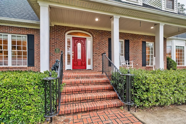 view of exterior entry featuring a porch