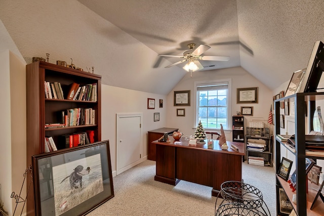 carpeted office featuring ceiling fan, lofted ceiling, and a textured ceiling