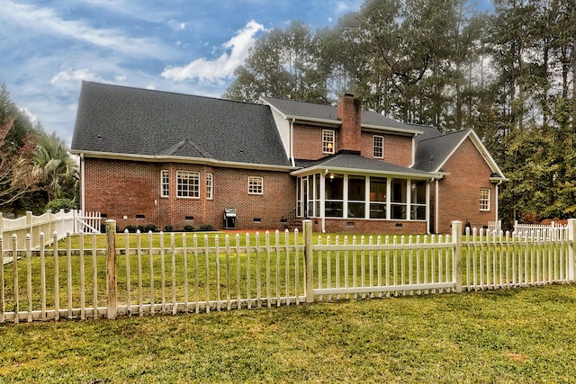 back of house featuring a sunroom and a yard