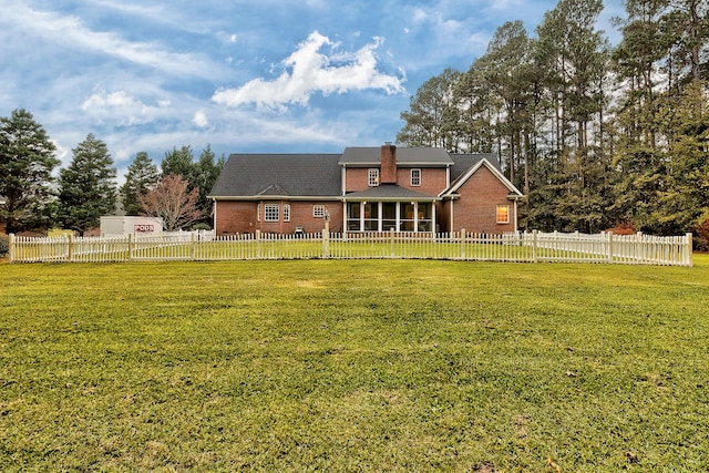 back of property featuring a yard