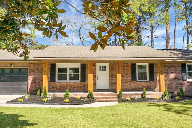 single story home with brick siding, an attached garage, concrete driveway, and a front lawn