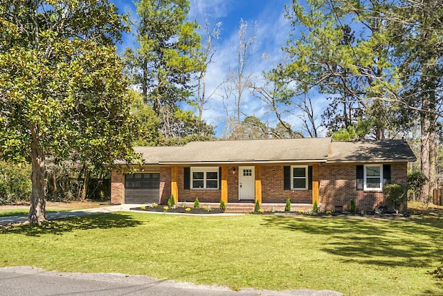 ranch-style house featuring brick siding, a front yard, a garage, crawl space, and driveway