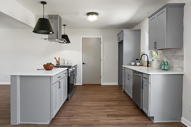 kitchen with dishwasher, gas range, wall chimney range hood, and gray cabinets