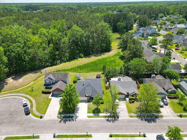 bird's eye view featuring a residential view and a wooded view