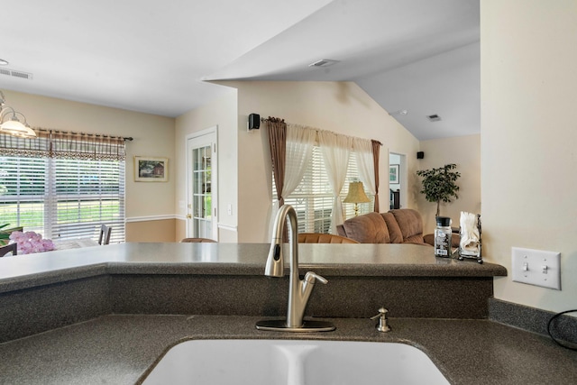 interior details featuring visible vents, a sink, and dark countertops