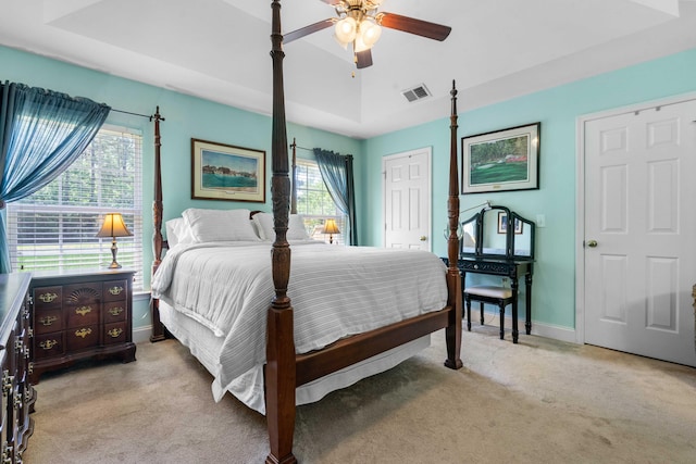 bedroom with visible vents, baseboards, a closet, and light colored carpet