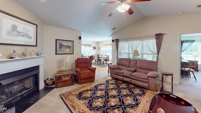 living room featuring visible vents, ceiling fan, a healthy amount of sunlight, and vaulted ceiling