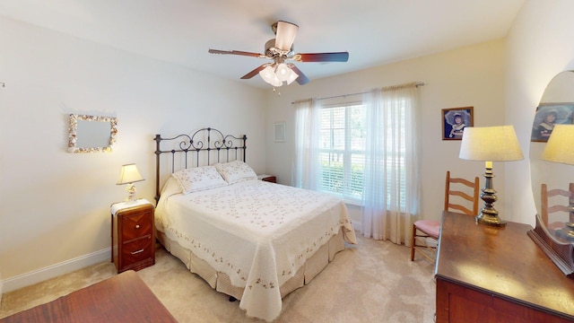 bedroom featuring baseboards, ceiling fan, and light carpet