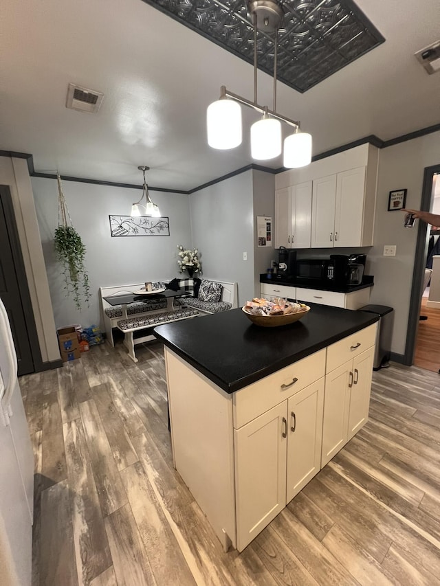 111 Newington Rd, Summerville, SC 29485 - kitchen featuring dark countertops, visible vents, and crown molding