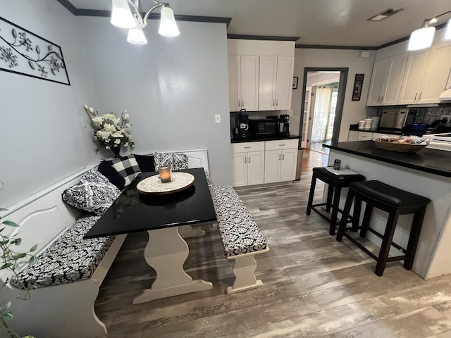 111 Newington Rd, Summerville, SC 29485 - dining space featuring visible vents, crown molding, a notable chandelier, and light wood finished floors