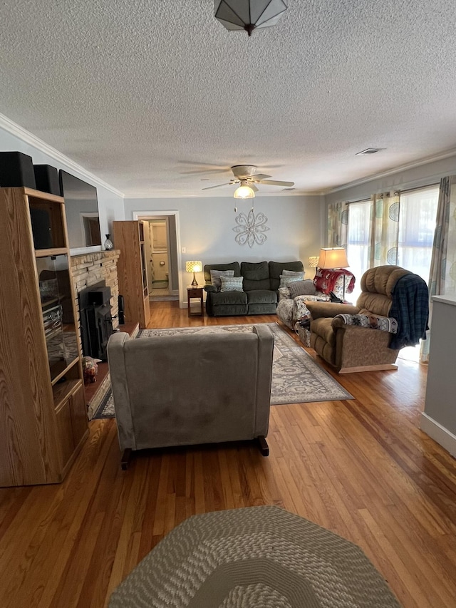 111 Newington Rd, Summerville, SC 29485 - living area featuring visible vents, ceiling fan, ornamental molding, hardwood / wood-style floors, and a fireplace