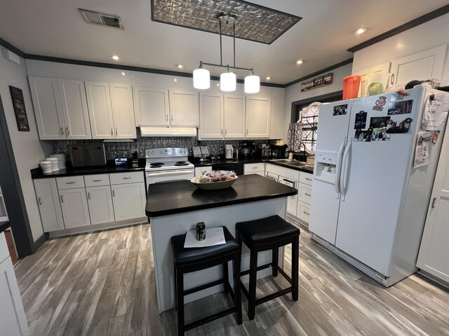 111 Newington Rd, Summerville, SC 29485 - kitchen featuring dark countertops, visible vents, a sink, white appliances, and under cabinet range hood