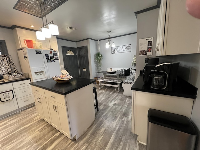 111 Newington Rd, Summerville, SC 29485 - kitchen with white refrigerator with ice dispenser, dark countertops, and crown molding