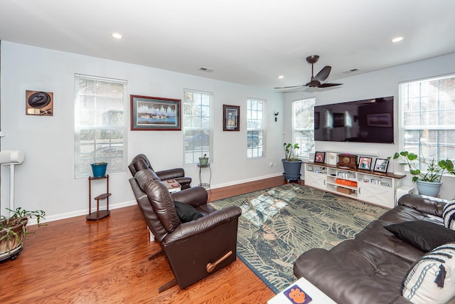 living room with hardwood / wood-style flooring and ceiling fan