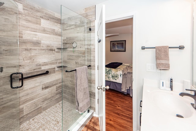 bathroom featuring hardwood / wood-style flooring, an enclosed shower, and vanity