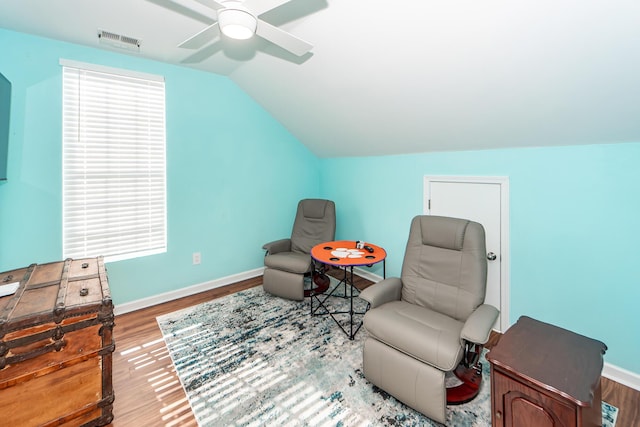 sitting room with vaulted ceiling, ceiling fan, and wood-type flooring