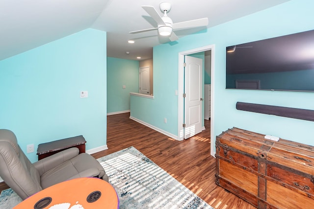 living room with ceiling fan and dark hardwood / wood-style floors