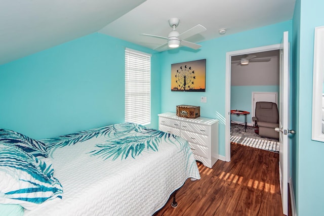 bedroom with ceiling fan, vaulted ceiling, and dark hardwood / wood-style floors