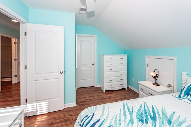 bedroom with ceiling fan, vaulted ceiling, and dark hardwood / wood-style flooring