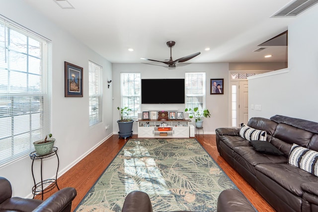 living room with ceiling fan and dark hardwood / wood-style floors