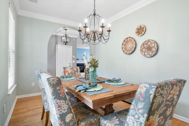 1458 Clarendon Way, Mount Pleasant, SC 29466 - dining area featuring a chandelier, arched walkways, light wood-style flooring, ornamental molding, and baseboards
