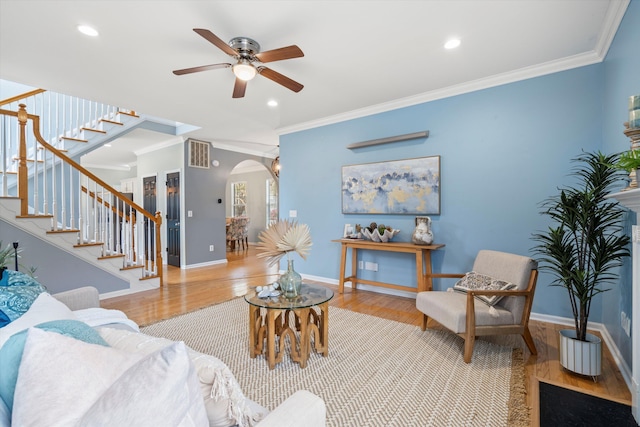1458 Clarendon Way, Mount Pleasant, SC 29466 - living room featuring wood finished floors, crown molding, stairs, a ceiling fan, and arched walkways