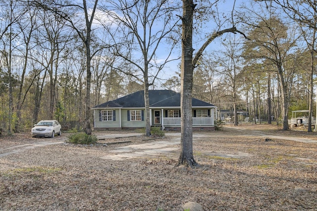 view of front facade with driveway, a porch, and crawl space