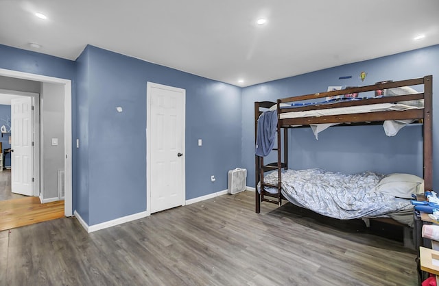 bedroom with recessed lighting, wood finished floors, visible vents, and baseboards