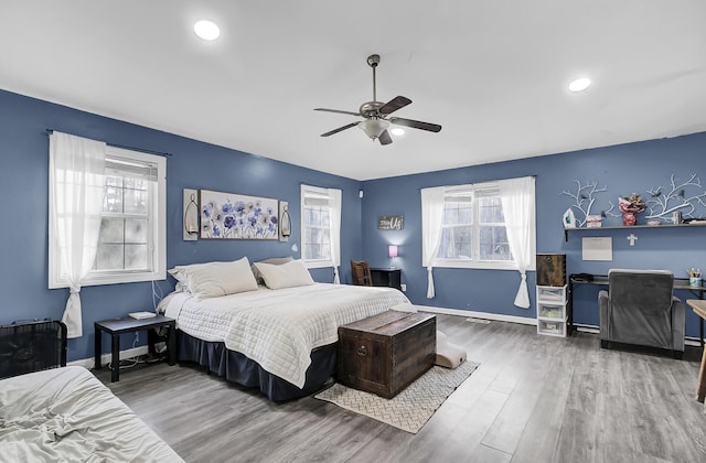 bedroom featuring ceiling fan, recessed lighting, wood finished floors, and baseboards