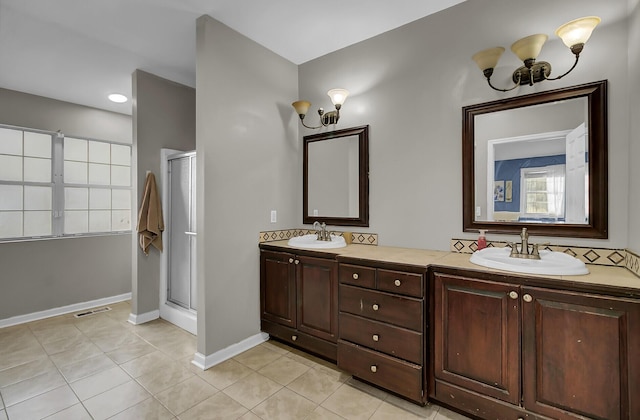 bathroom with tile patterned flooring, visible vents, and a sink