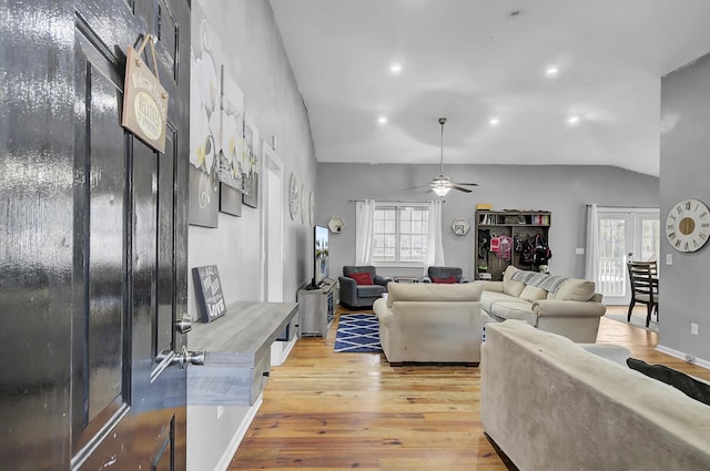 living area featuring lofted ceiling, plenty of natural light, light wood-style flooring, and recessed lighting