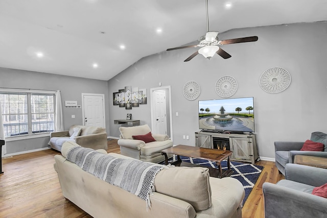 living room featuring vaulted ceiling, recessed lighting, wood finished floors, and baseboards