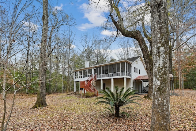 back of property featuring a sunroom