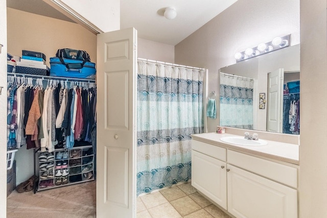 bathroom featuring curtained shower and vanity