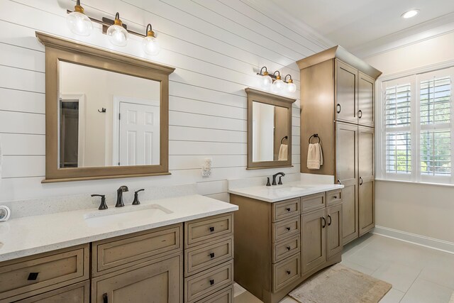 full bathroom featuring baseboards, tile patterned floors, ornamental molding, and a sink