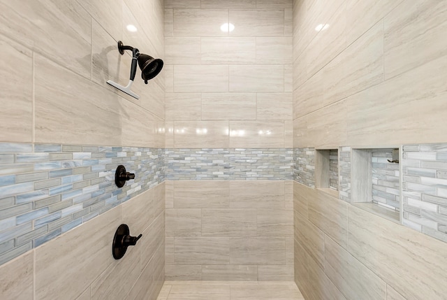 bathroom with a tile shower