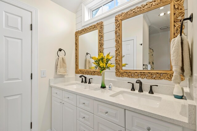full bathroom featuring a sink and double vanity