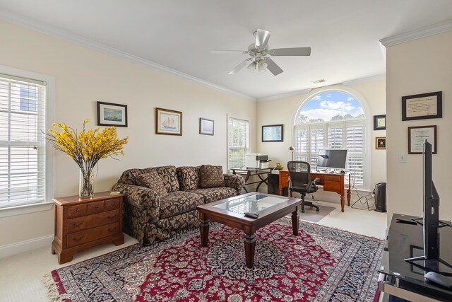 carpeted living area with baseboards, ceiling fan, ornamental molding, and visible vents