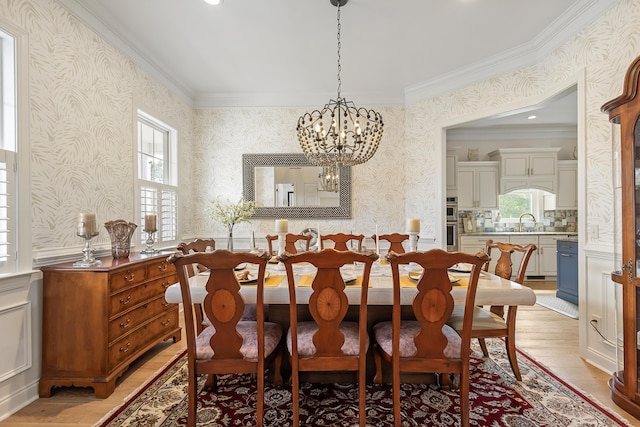 dining space with crown molding, wallpapered walls, plenty of natural light, and light wood-style flooring