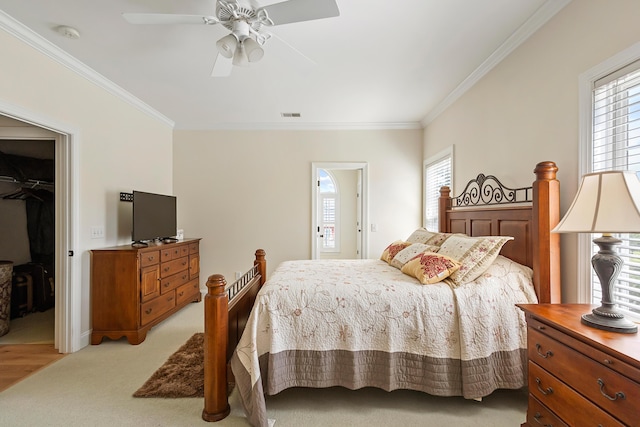 bedroom featuring crown molding, a spacious closet, multiple windows, and visible vents