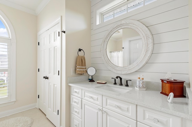 bathroom with crown molding, tile patterned floors, and vanity