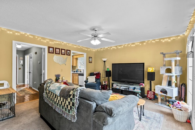 living room with a textured ceiling and ceiling fan